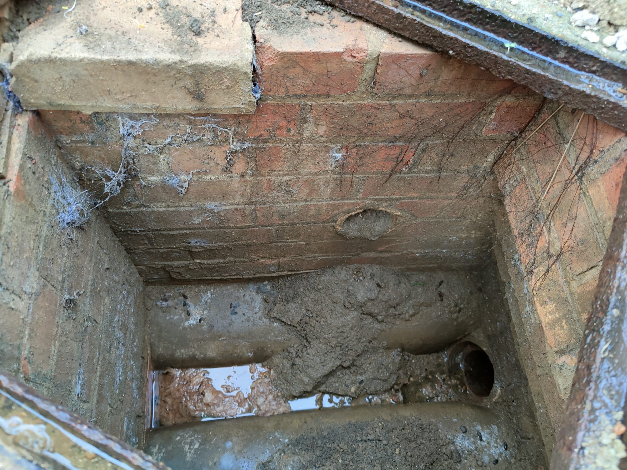 shows the redundant line for the old air vent half way up the manhole wall.  