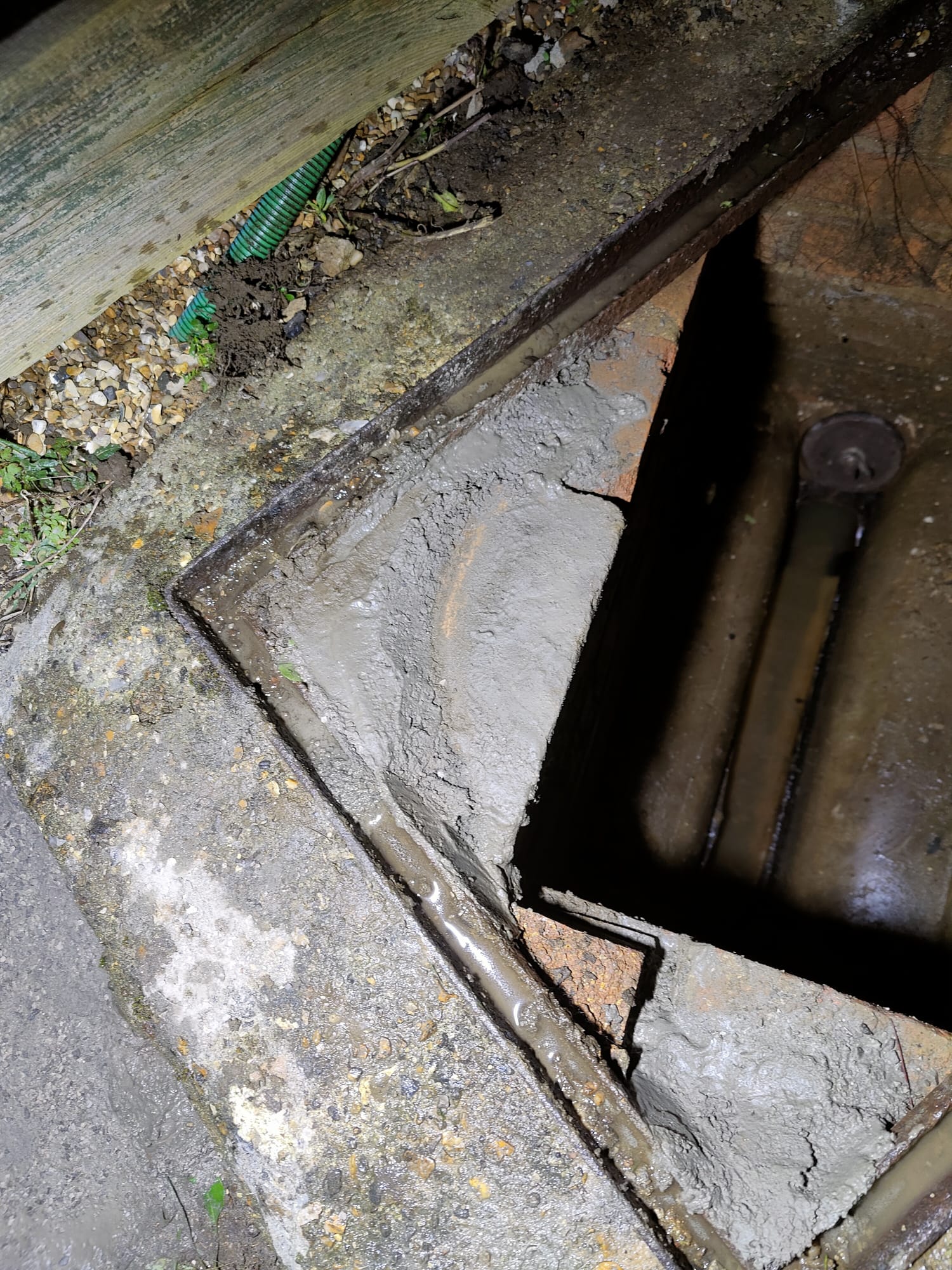 Manhole cover and frame after sealing holes with rapid set concrete