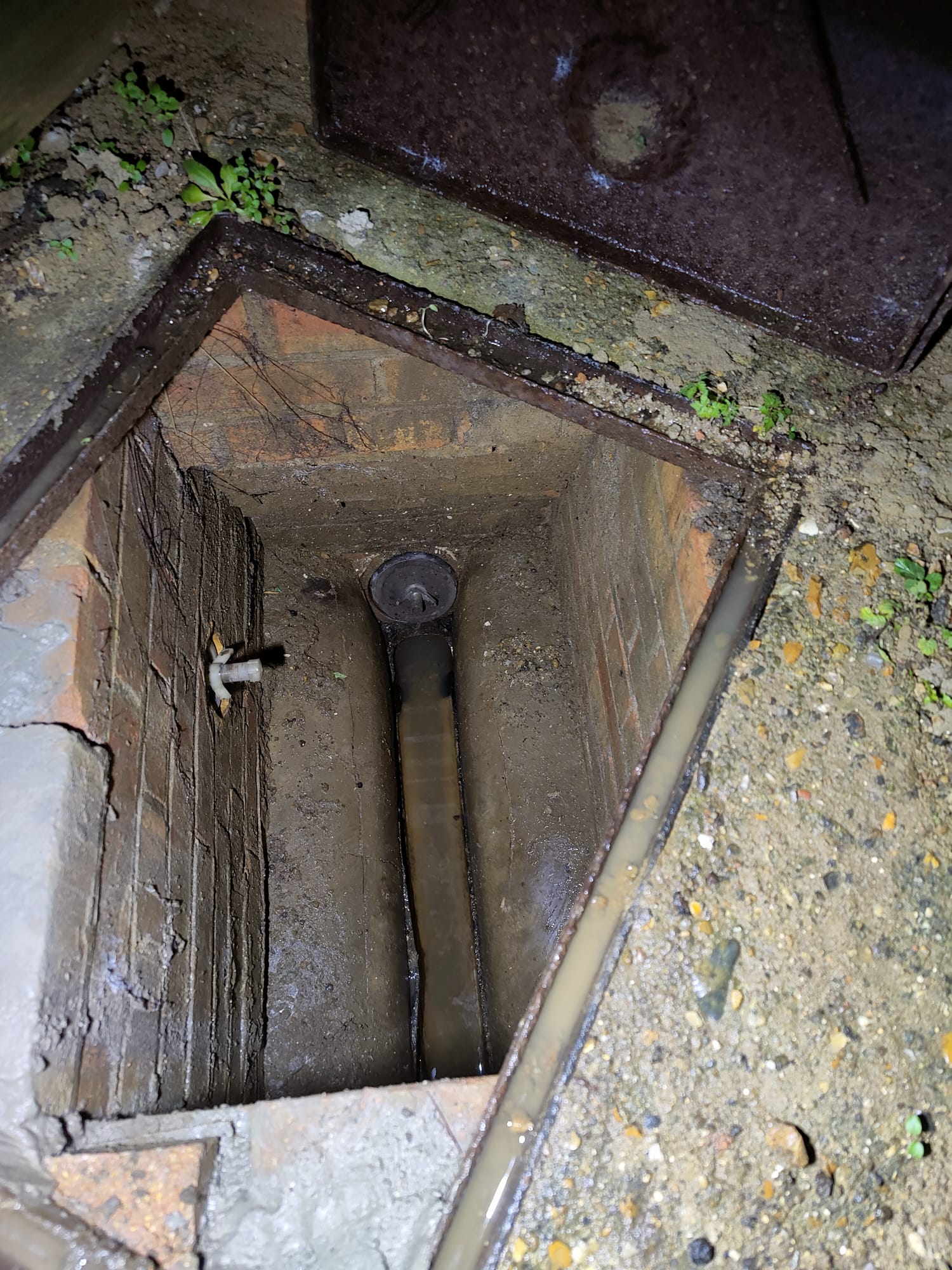 Manhole and drain winsor trap with drain stopper bung installed to seal